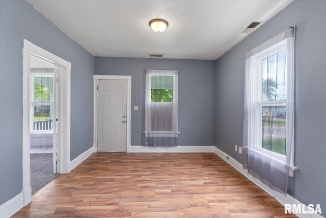 720 Wilkes Ave, Davenport, IA 52802 - entryway featuring light wood-type flooring, baseboards, and a textured ceiling