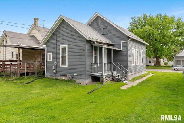 720 Wilkes Ave, Davenport, IA 52802 - rear view of house featuring a lawn and a wooden deck