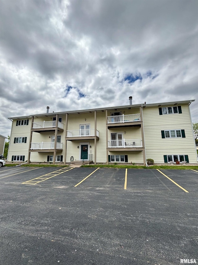 view of building exterior featuring uncovered parking