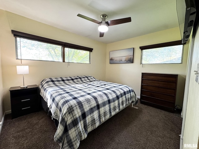 bedroom with dark carpet, baseboards, and ceiling fan