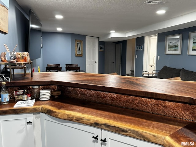bar with recessed lighting and a textured ceiling