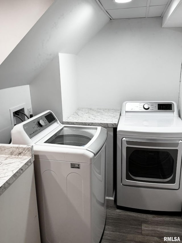 laundry room with separate washer and dryer and dark wood-style flooring