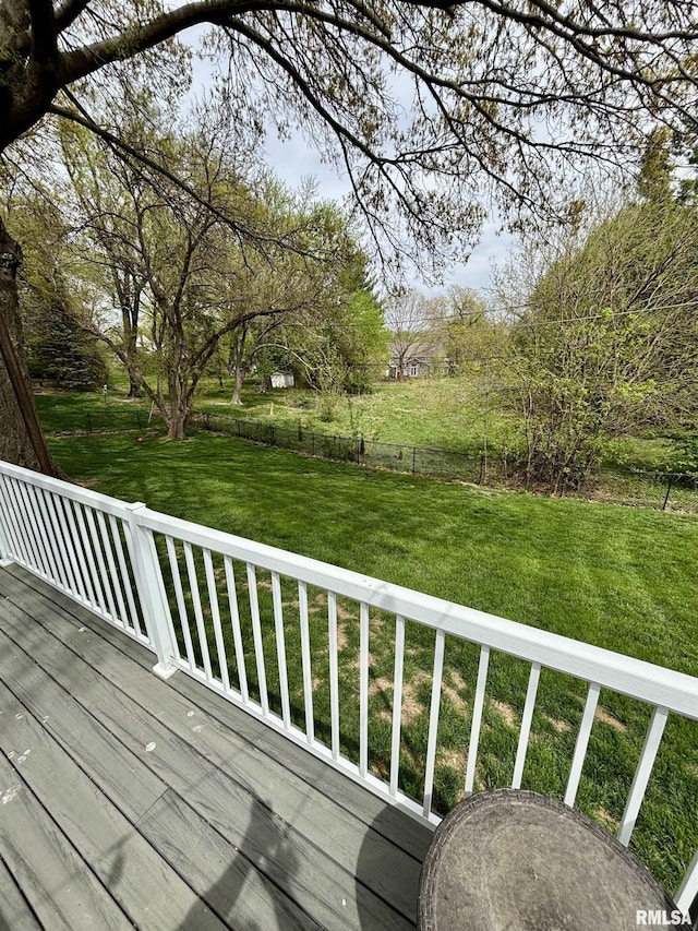 wooden deck with a lawn