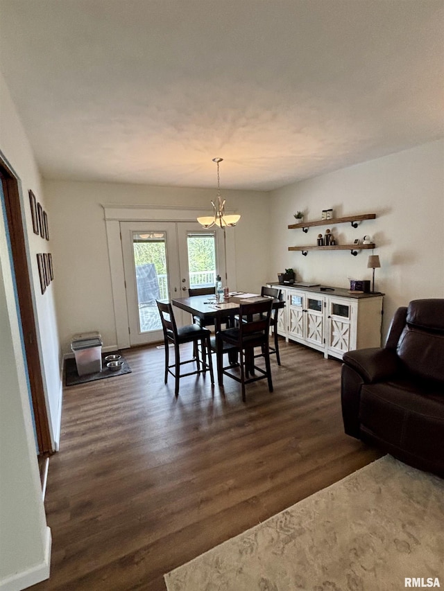 dining area featuring dark wood-style floors, a chandelier, and french doors