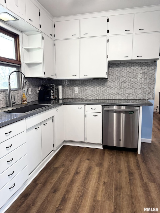kitchen with dishwasher, a sink, dark countertops, and dark wood-style floors