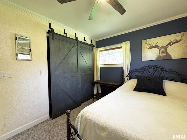 bedroom with carpet flooring, baseboards, a barn door, a textured wall, and ornamental molding