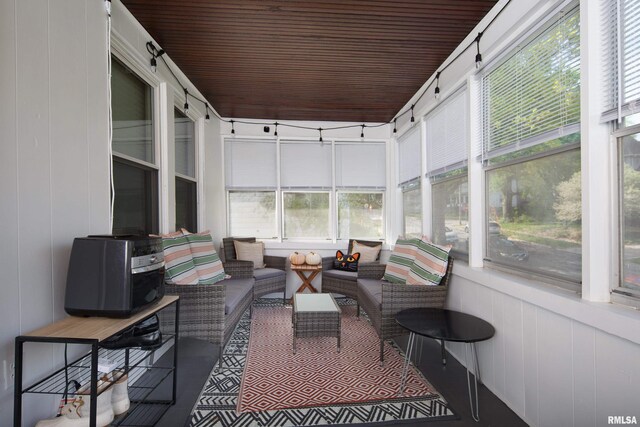 sunroom with plenty of natural light and an outdoor living space