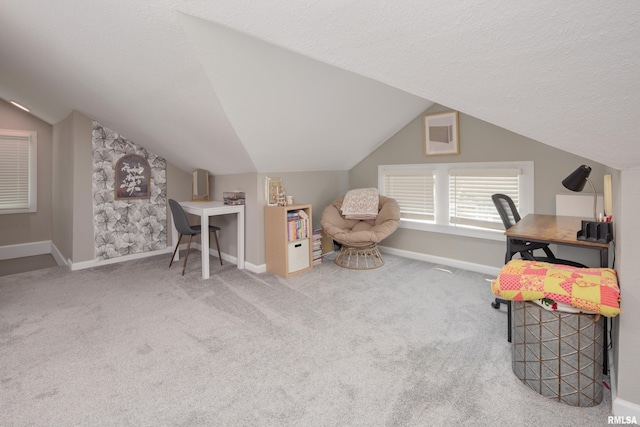 carpeted office with lofted ceiling, baseboards, and a textured ceiling