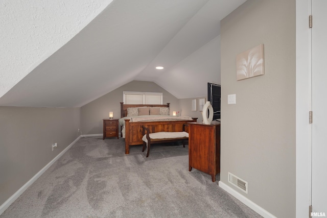 carpeted bedroom with lofted ceiling and baseboards