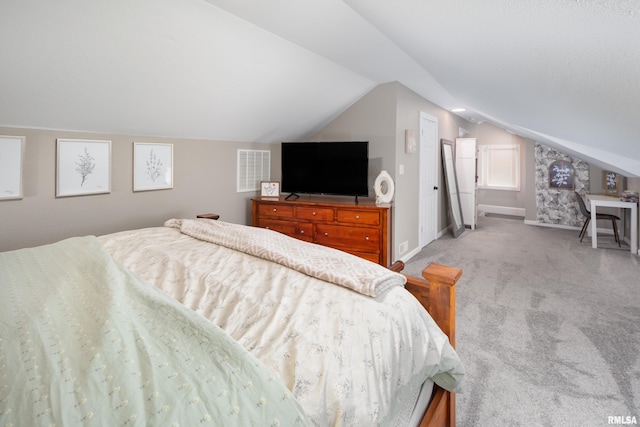 bedroom with vaulted ceiling, light colored carpet, and baseboards