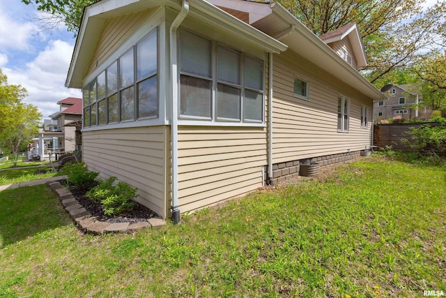 view of home's exterior with a sunroom