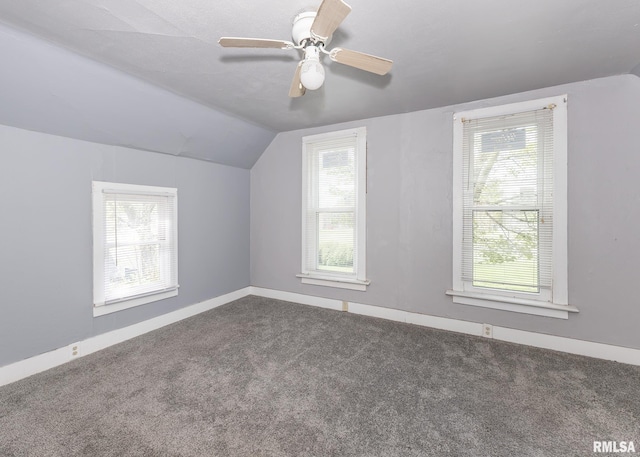 additional living space with vaulted ceiling, carpet floors, baseboards, and a ceiling fan