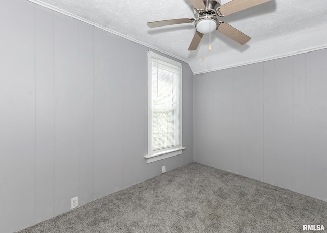 empty room featuring carpet flooring, a ceiling fan, and a textured ceiling