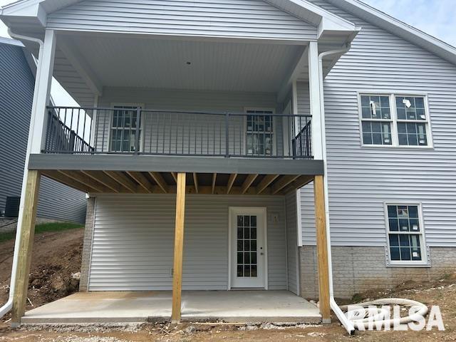 back of house with a patio area and a balcony
