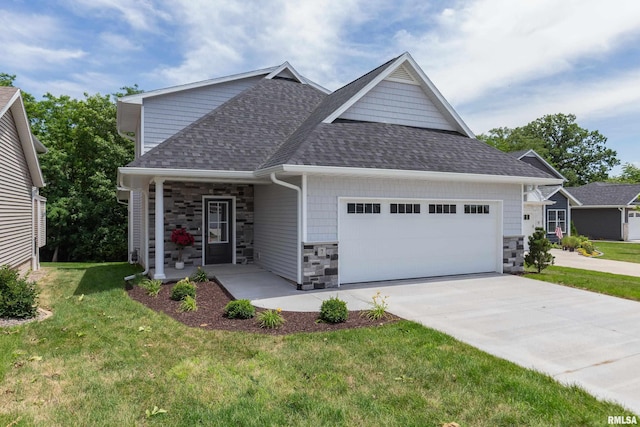 7 Welcome Center Ct, Le Claire, IA 52753 - view of front of property with stone siding, roof with shingles, an attached garage, a front lawn, and concrete driveway