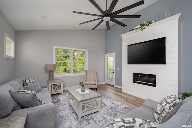 7 Welcome Center Ct, Le Claire, IA 52753 - living area featuring lofted ceiling, ceiling fan, a fireplace, and wood finished floors