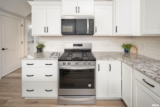 7 Welcome Center Ct, Le Claire, IA 52753 - kitchen with appliances with stainless steel finishes, tasteful backsplash, white cabinets, and light wood-type flooring