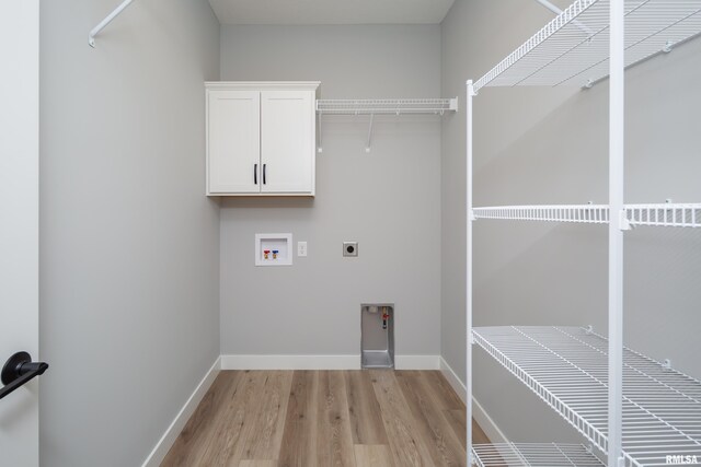 7 Welcome Center Ct, Le Claire, IA 52753 - laundry room with hookup for a washing machine, electric dryer hookup, light wood-style flooring, and cabinet space