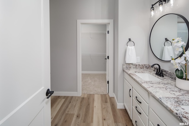7 Welcome Center Ct, Le Claire, IA 52753 - bathroom with double vanity, wood finished floors, and a walk in closet