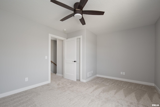 7 Welcome Center Ct, Le Claire, IA 52753 - unfurnished bedroom featuring carpet floors and ceiling fan