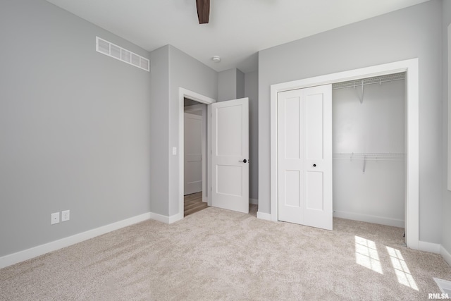 7 Welcome Center Ct, Le Claire, IA 52753 - unfurnished bedroom with carpet flooring, a closet, and a ceiling fan