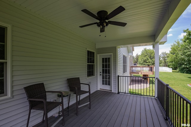 7 Welcome Center Ct, Le Claire, IA 52753 - wooden terrace with a ceiling fan and a lawn