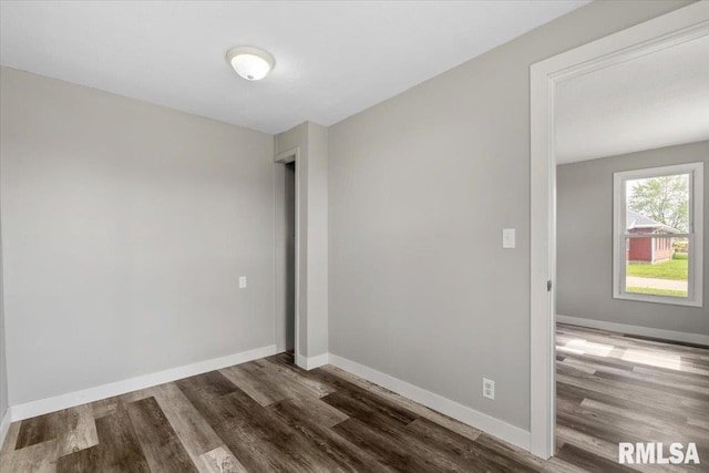 empty room with wood finished floors and baseboards
