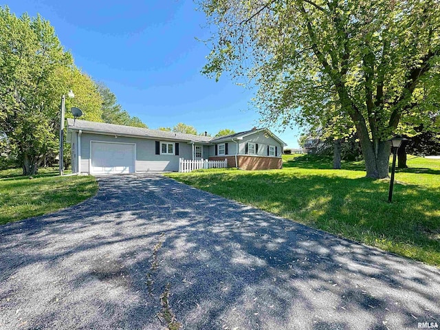 single story home with a garage, asphalt driveway, and a front lawn