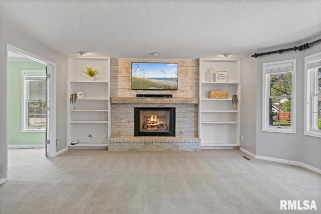 4690 Lindbergh Dr, Bettendorf, IA 52722 - unfurnished living room featuring a textured ceiling, carpet floors, a fireplace, and baseboards