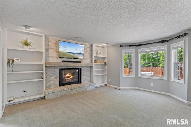 4690 Lindbergh Dr, Bettendorf, IA 52722 - unfurnished living room featuring a brick fireplace, a textured ceiling, carpet flooring, built in features, and baseboards
