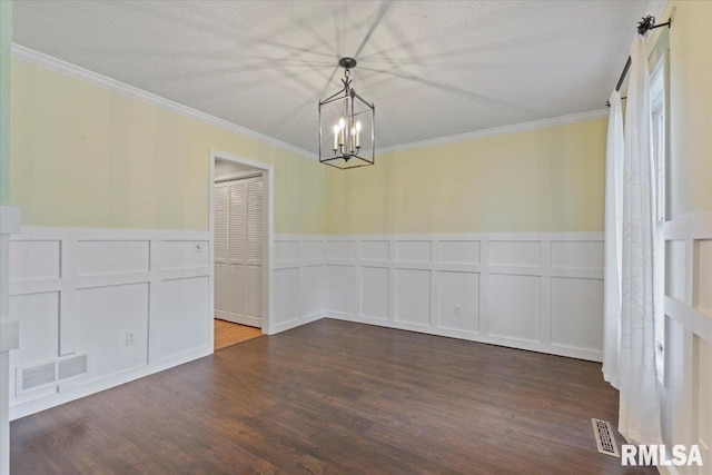 4690 Lindbergh Dr, Bettendorf, IA 52722 - unfurnished dining area featuring a decorative wall, a chandelier, crown molding, dark wood-style flooring, and a wainscoted wall