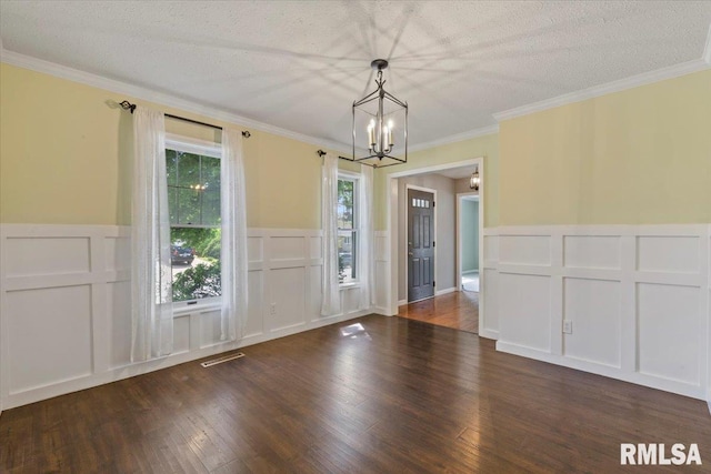 4690 Lindbergh Dr, Bettendorf, IA 52722 - unfurnished dining area featuring a decorative wall, a chandelier, wood finished floors, a wainscoted wall, and ornamental molding