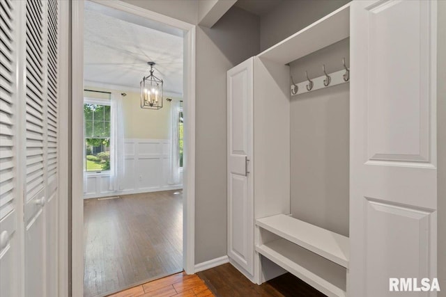4690 Lindbergh Dr, Bettendorf, IA 52722 - mudroom featuring hardwood / wood-style floors and a chandelier