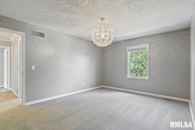 4690 Lindbergh Dr, Bettendorf, IA 52722 - carpeted empty room featuring a textured ceiling, a chandelier, and baseboards