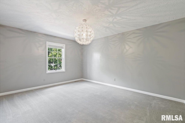 4690 Lindbergh Dr, Bettendorf, IA 52722 - carpeted spare room featuring a chandelier, baseboards, and a textured ceiling