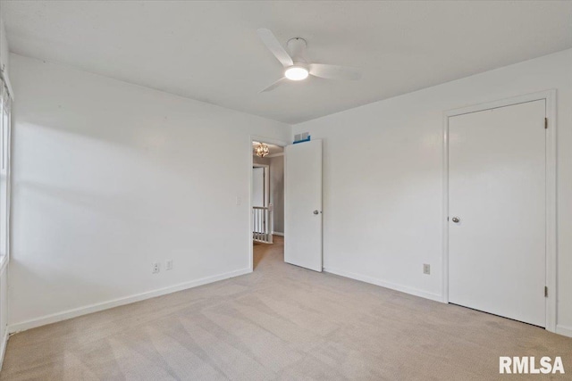 4690 Lindbergh Dr, Bettendorf, IA 52722 - unfurnished bedroom with carpet floors, baseboards, and a ceiling fan