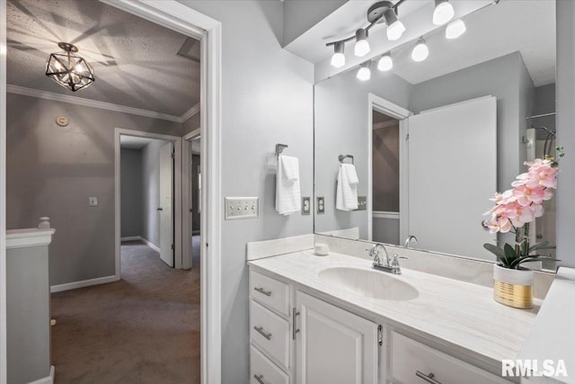 4690 Lindbergh Dr, Bettendorf, IA 52722 - bathroom featuring vanity, crown molding, and baseboards