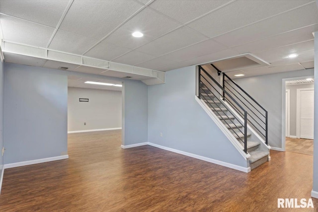 4690 Lindbergh Dr, Bettendorf, IA 52722 - finished basement with wood finished floors, baseboards, stairway, and a drop ceiling