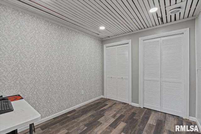 4690 Lindbergh Dr, Bettendorf, IA 52722 - unfurnished bedroom with two closets, dark wood-style floors, recessed lighting, baseboards, and wallpapered walls