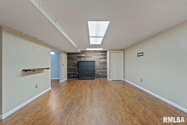 4690 Lindbergh Dr, Bettendorf, IA 52722 - unfurnished living room with baseboards, wood finished floors, a drop ceiling, and a fireplace