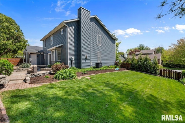 4690 Lindbergh Dr, Bettendorf, IA 52722 - back of property featuring a patio, a chimney, and central air condition unit