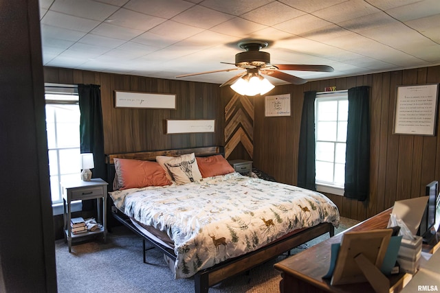 129 E High St, Mendon, IL 62351 - bedroom featuring carpet, wooden walls, and a ceiling fan