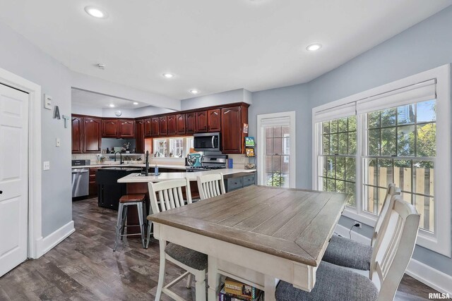 dining room with recessed lighting, dark wood-style floors, and baseboards