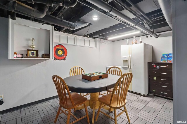 dining space with baseboards and tile patterned floors