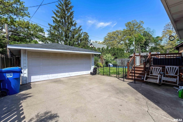 detached garage featuring fence