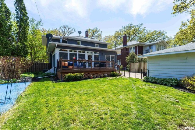 back of house with a deck and a sunroom
