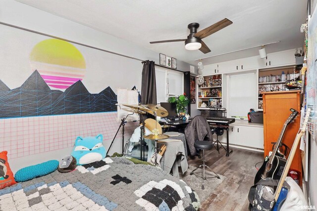 bedroom with wood finished floors and ceiling fan
