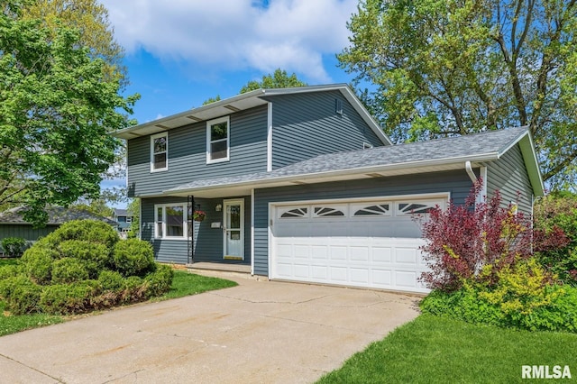 1960 Tam-O-Shanter Dr, Bettendorf, IA 52722 - view of front of home featuring an attached garage, concrete driveway, and roof with shingles
