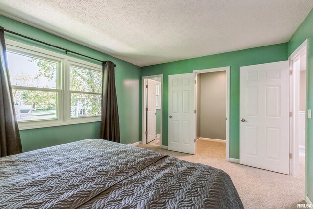 1960 Tam-O-Shanter Dr, Bettendorf, IA 52722 - bedroom with light colored carpet, a textured ceiling, and baseboards