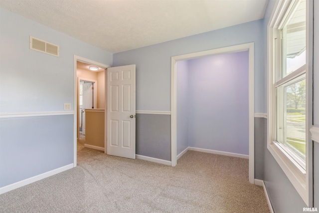 1960 Tam-O-Shanter Dr, Bettendorf, IA 52722 - unfurnished bedroom with carpet, baseboards, and a textured ceiling